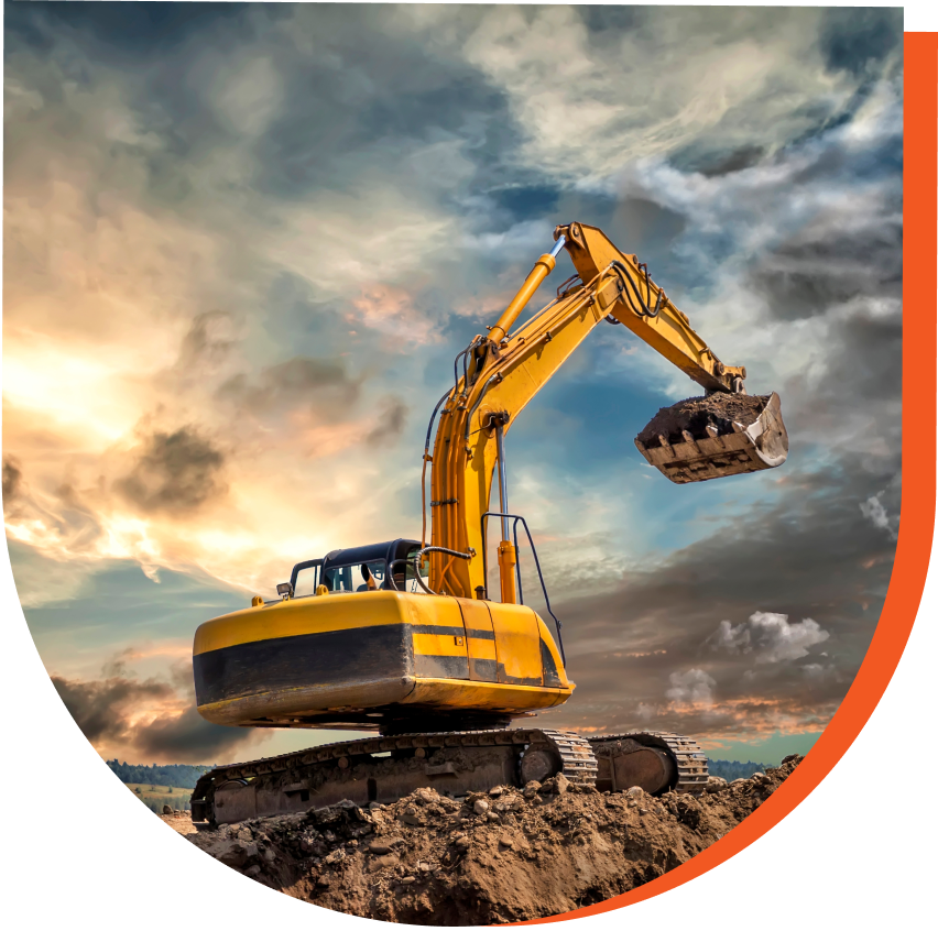 A yellow excavator with a raised bucket sits on a dirt mound under a cloudy sky.